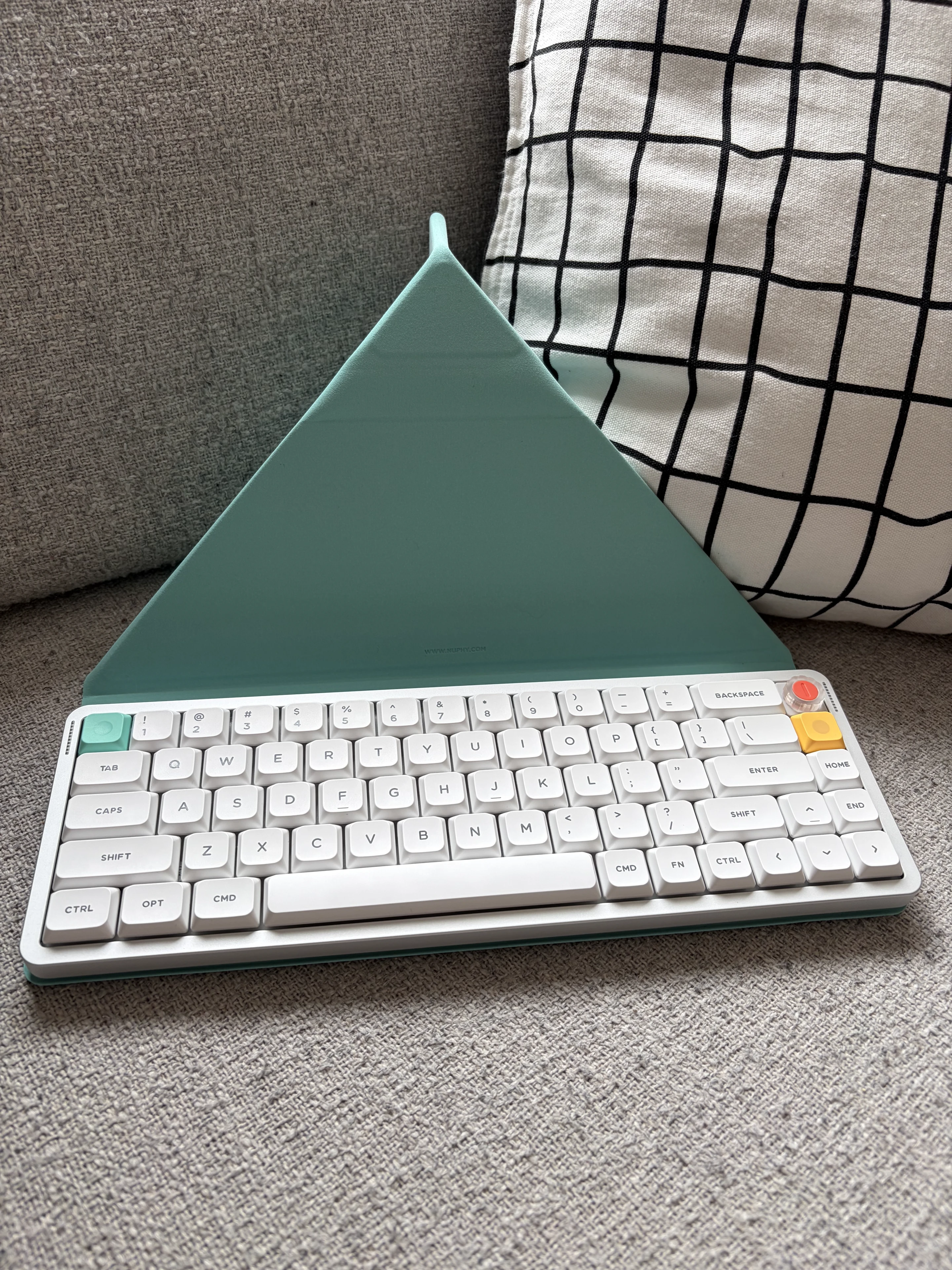 NuPhy Air V3 65 on the mint green folio cover folded into the tent mode ready for a tablet