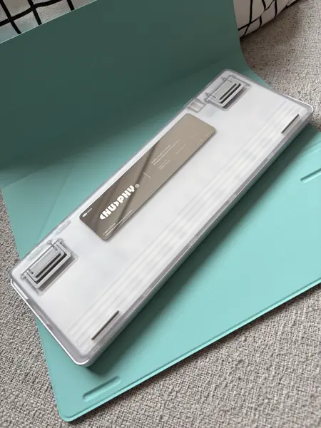 Back of the NuPhy Air V3 65 on the mint green folio showing the shiney metal plate