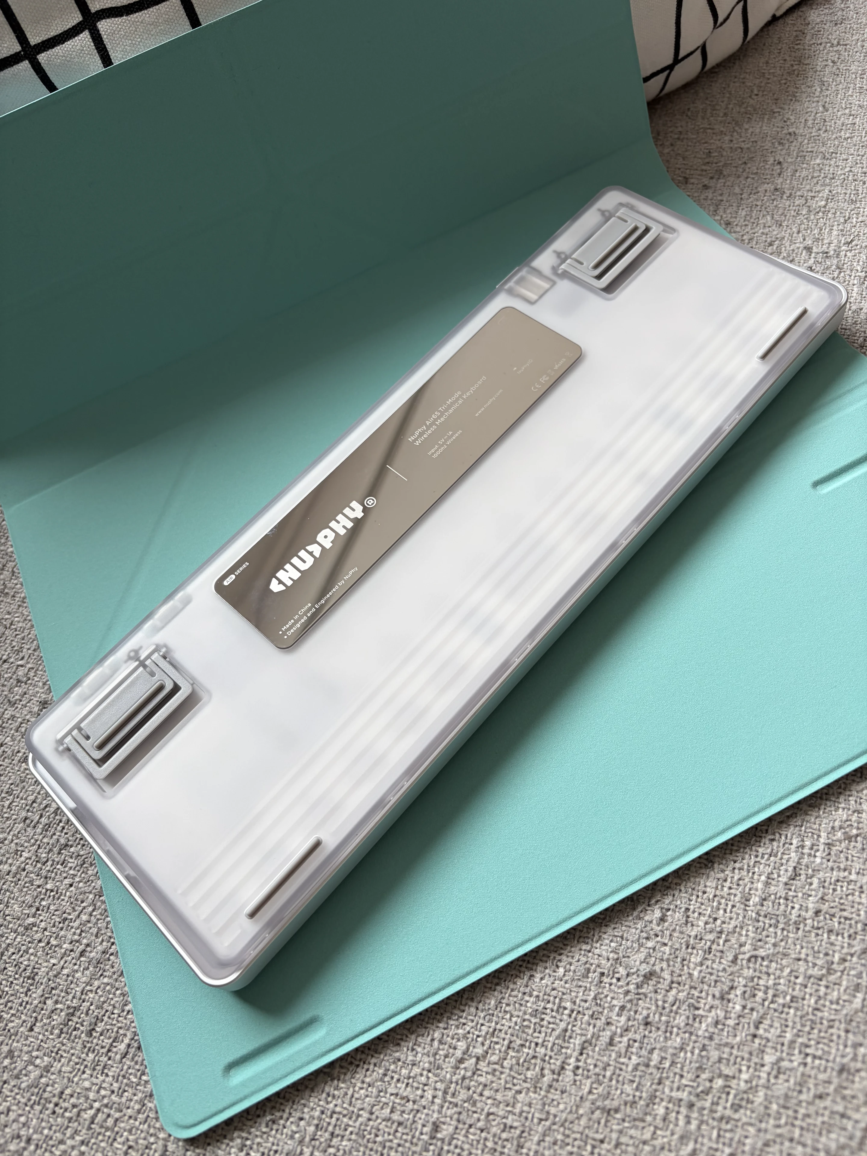 Back of the NuPhy Air V3 65 on the mint green folio showing the shiney metal plate